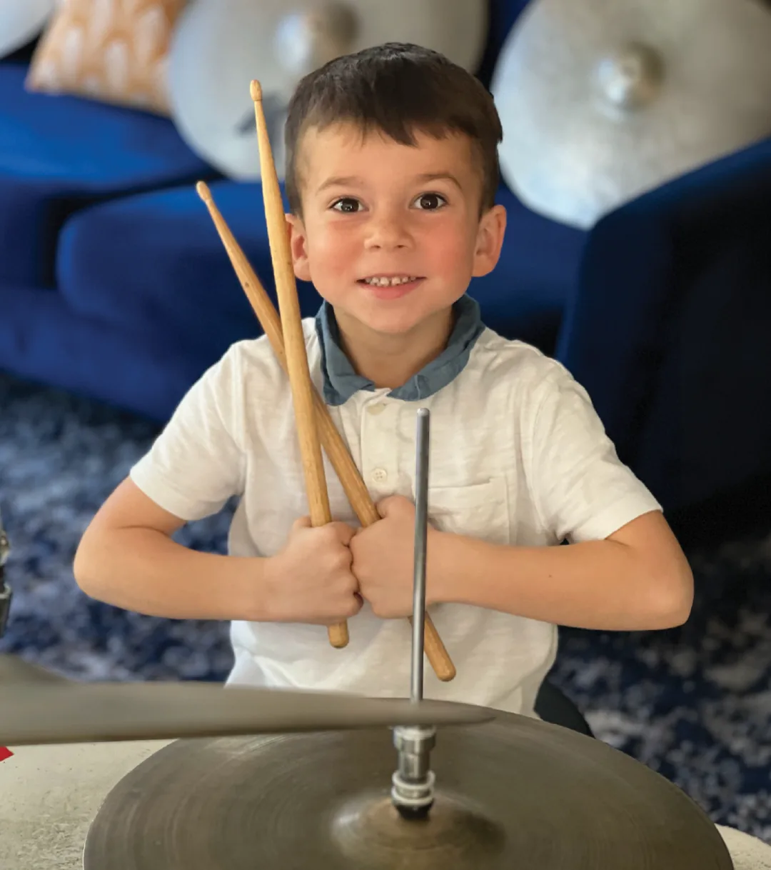 Young OC Drum Academy student holding drumsticks during a private drum lesson in Tustin Young OC Drum Academy student holding drumsticks during a private drum lesson in Tustin