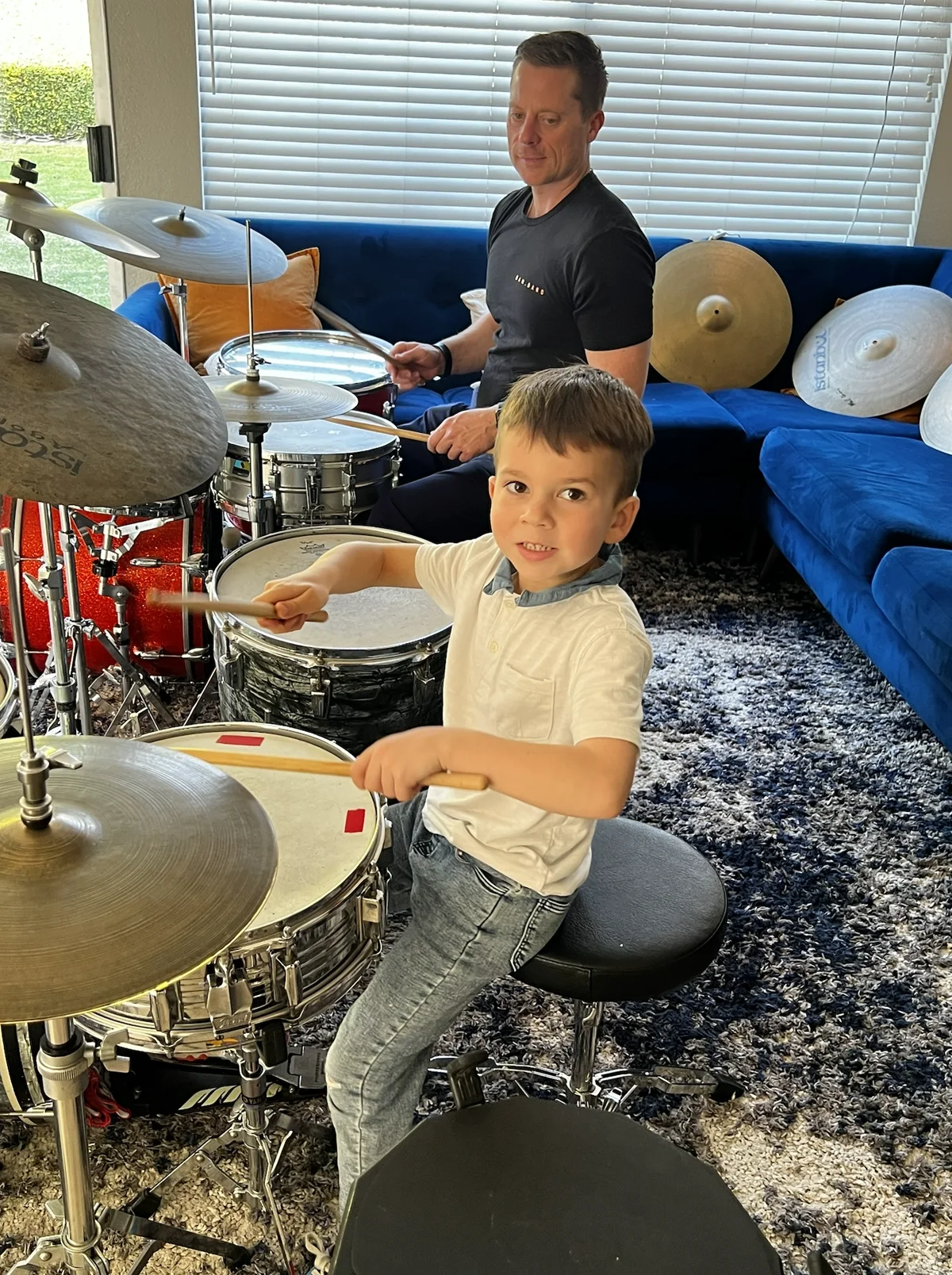 OC Drum Academy instructor guiding a young student during a trial drum lesson in Tustin
